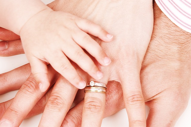 Parents and child's hand stacked together.